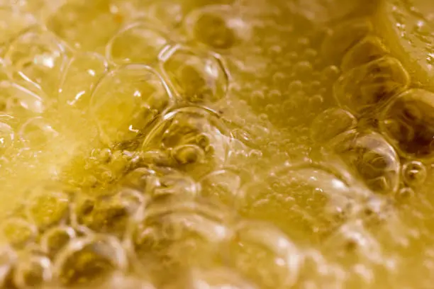 Close-up of bubbling liquid with foam.