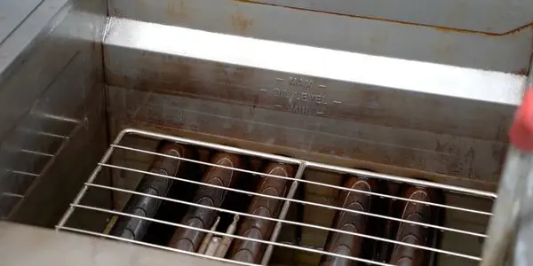 Grill with metal rods inside industrial oven.